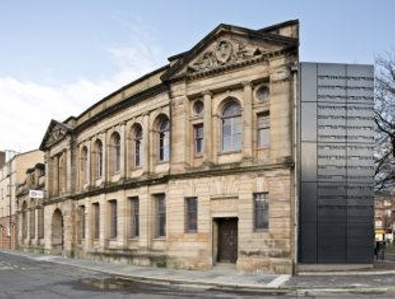 View of the outside of the Glasgow Women's Library. It presents as regal, old, sandstone building.